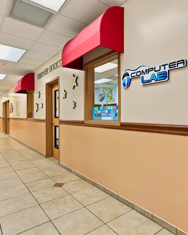 Bright hallway lined with classroom windows and the Computer Lab entrance