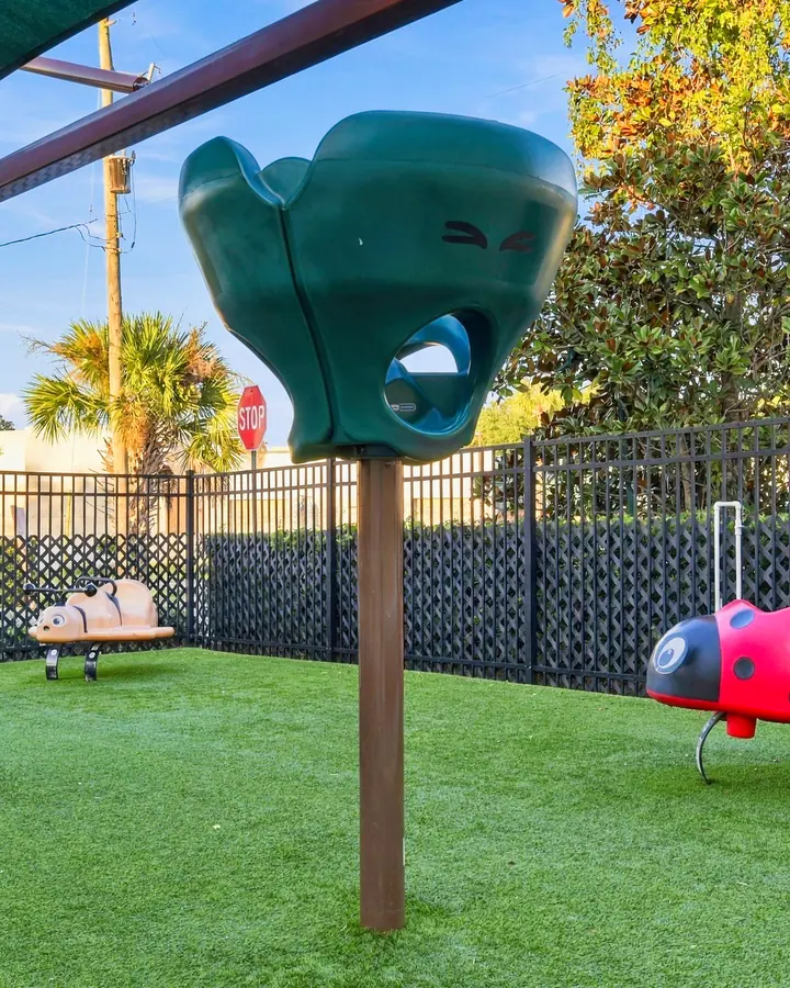 Ladybug spring rider and climbing pieces on the turf playground