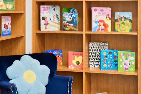 Bookshelf of children's books and a cozy reading armchair