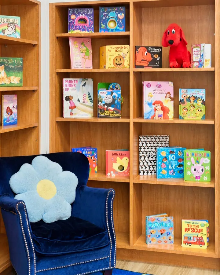 Bookshelf of children's books and a cozy reading armchair