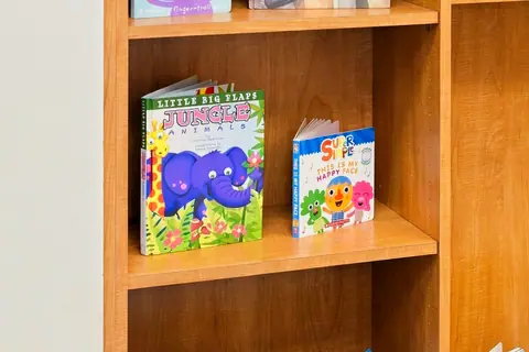 Children's books displayed on reading room shelves