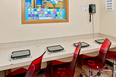 Row of tablets and red chairs in the computer lab