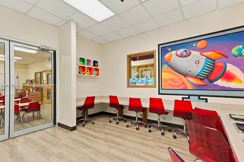 Computer lab tablet stations with red chairs