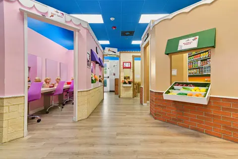 PlayTown pretend-play village with a grocery stand and storefronts