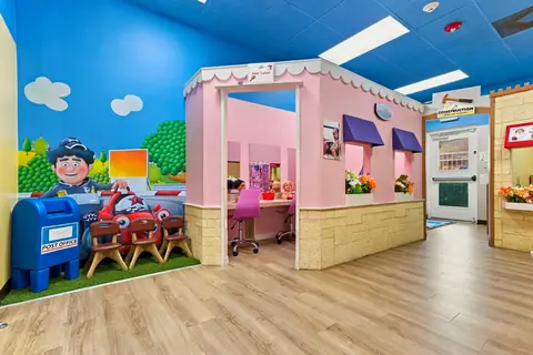 PlayTown post office corner and pink storefronts