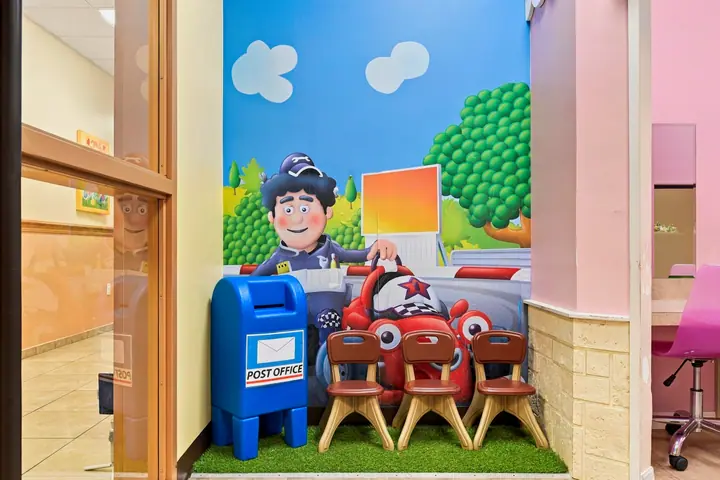 Pretend post office with a mailbox, toy car and child-size chairs