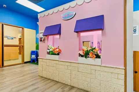 Pink PlayTown storefront with window boxes of flowers
