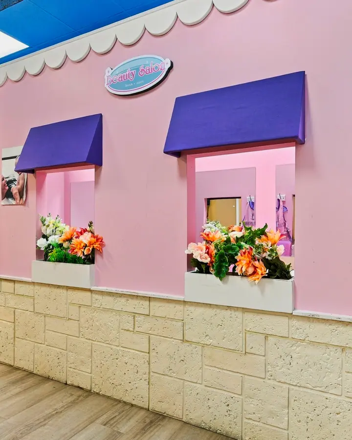 Pink PlayTown storefront with window boxes of flowers
