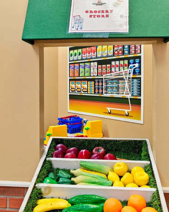 Pretend grocery stand stocked with play fruit and vegetables
