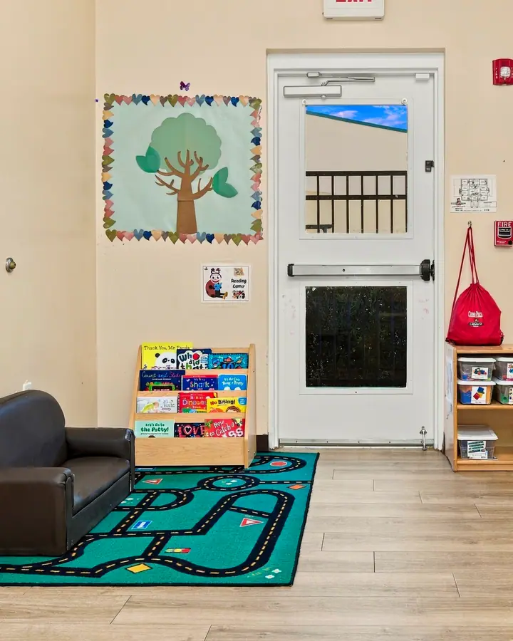 Cozy classroom corner with a child-size couch and a road play rug