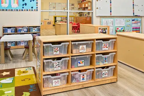 Classroom learning center shelves with labeled bins