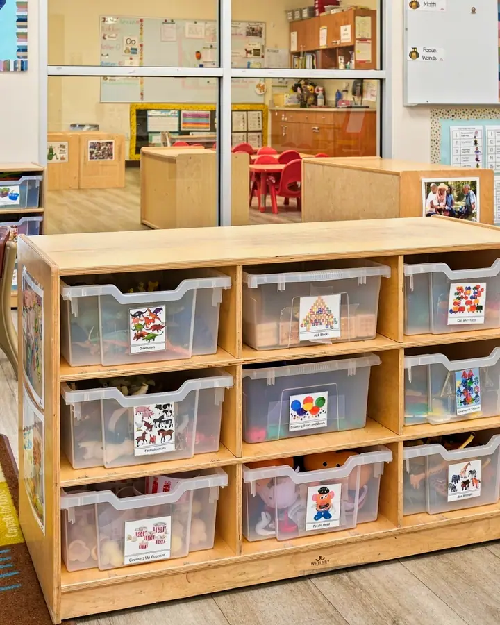 Classroom learning center shelves with labeled bins