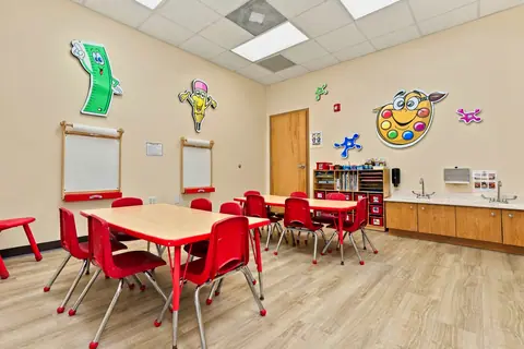 Art Studio with red tables, easels and supply shelves