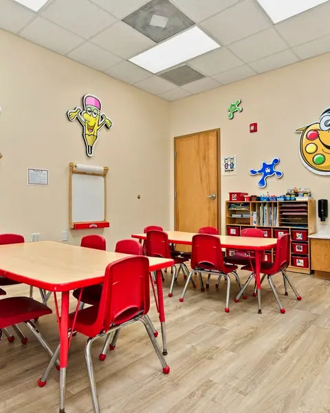 Art Studio with red tables, easels and supply shelves