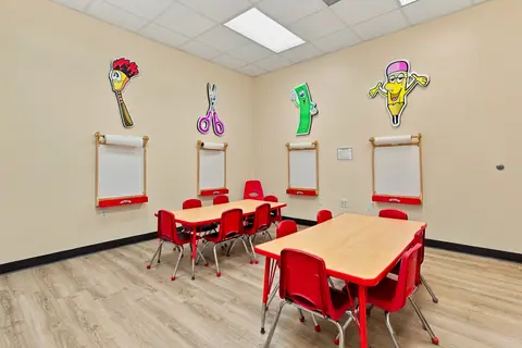 Art Studio tables beneath wall-mounted paper easels