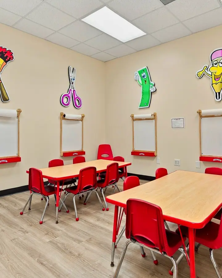 Art Studio tables beneath wall-mounted paper easels