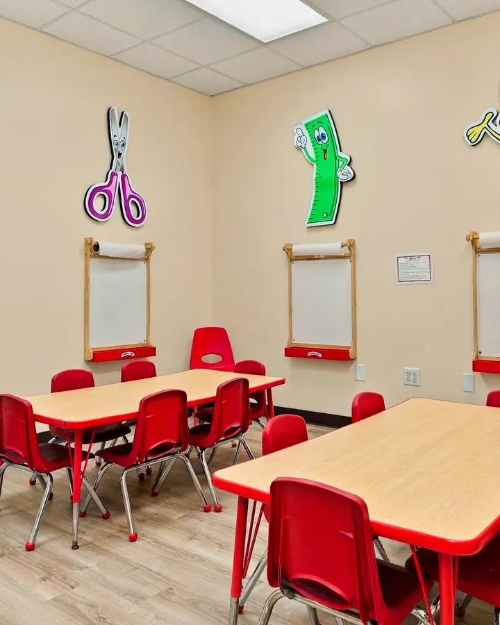 Art Studio easels and red tables ready for painting